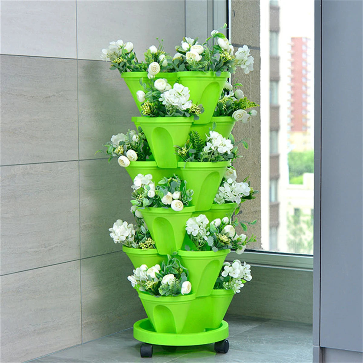 Bright green stackable vertical herb planter with four-tier pots and white flowers