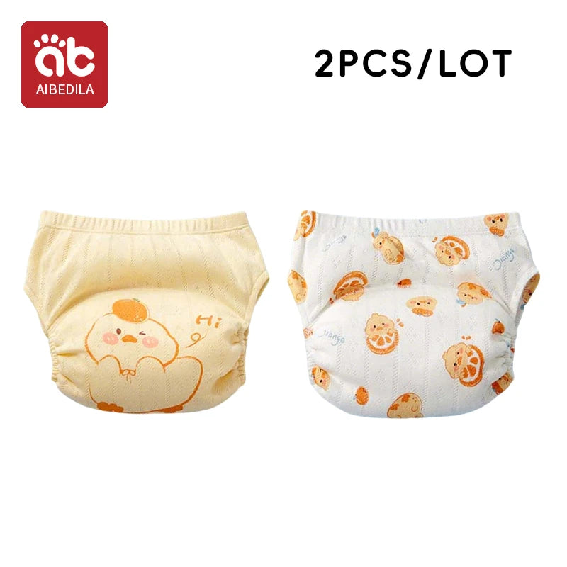 AIBEDILA 2-pack reusable baby training pants with cute chick and orange fruit prints for toddler potty training.