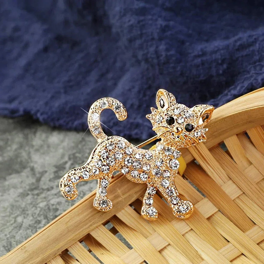 Gold-tone cat brooch with sparkling crystals, perfect as a stylish lapel pin or unique gift for cat lovers.