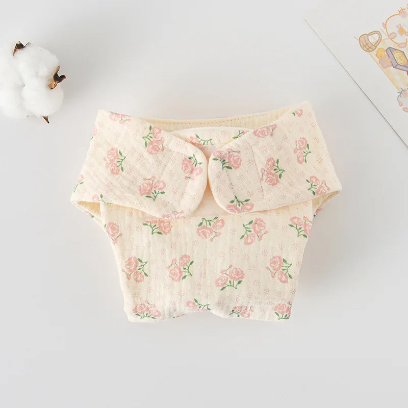 Floral print muslin cloth baby diaper cover with Velcro closure. Soft beige fabric for baby care.