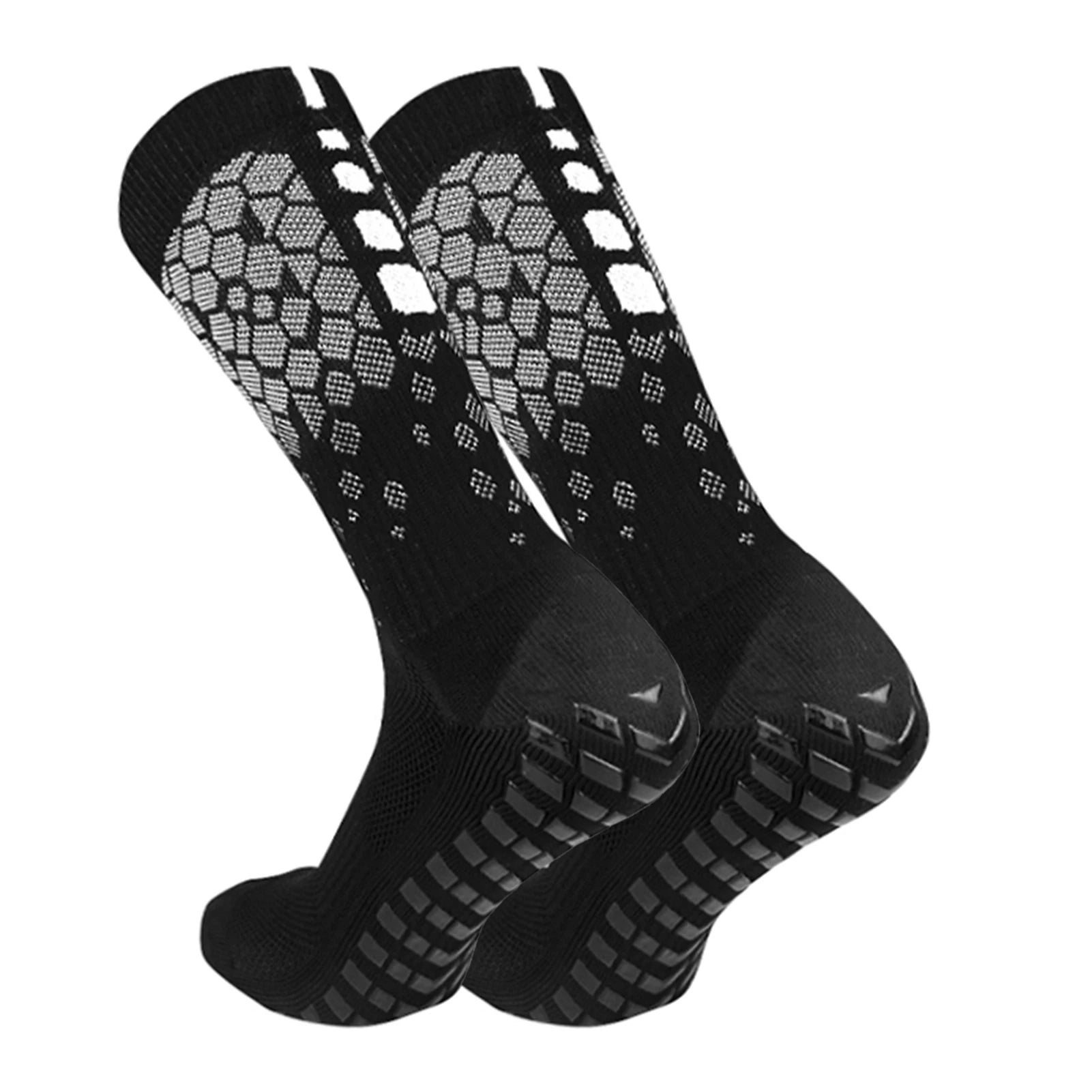 Pair of black athletic Tidesmit socks with grey honeycomb patterns and black rubber grip soles for traction.