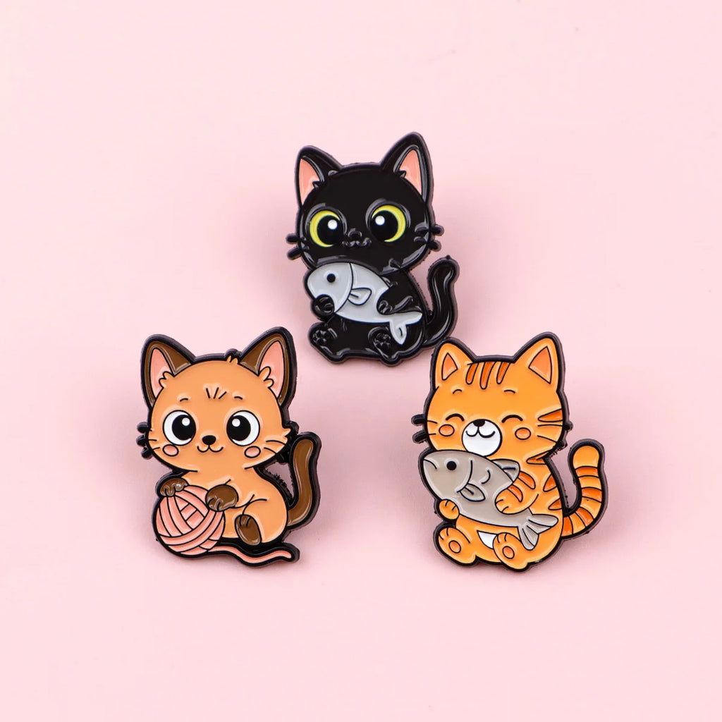 Cute cat enamel pin set, featuring tabby and black kittens with fish and yarn, perfect for backpacks or lapel jewelry.