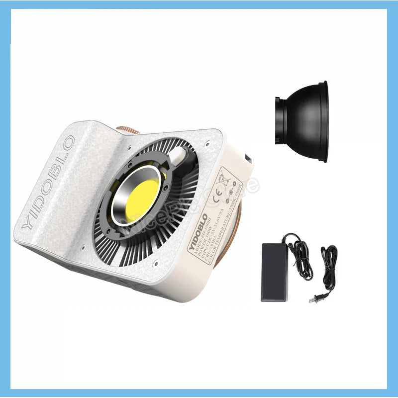 White LED video light with COB chip, cooling fan, reflector hood, and power adapter for photography and videography.