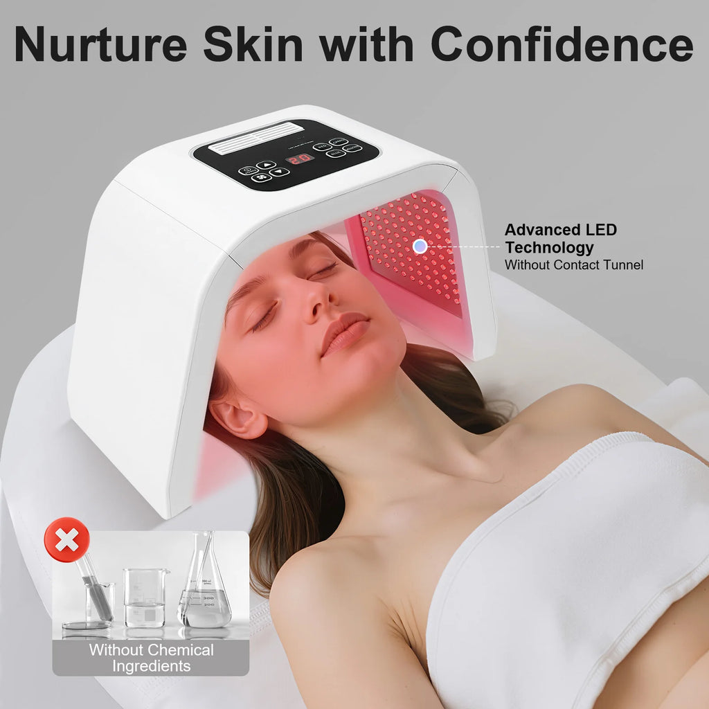 A person receives a red LED light therapy treatment under a white, tunnel-style facial salon machine.