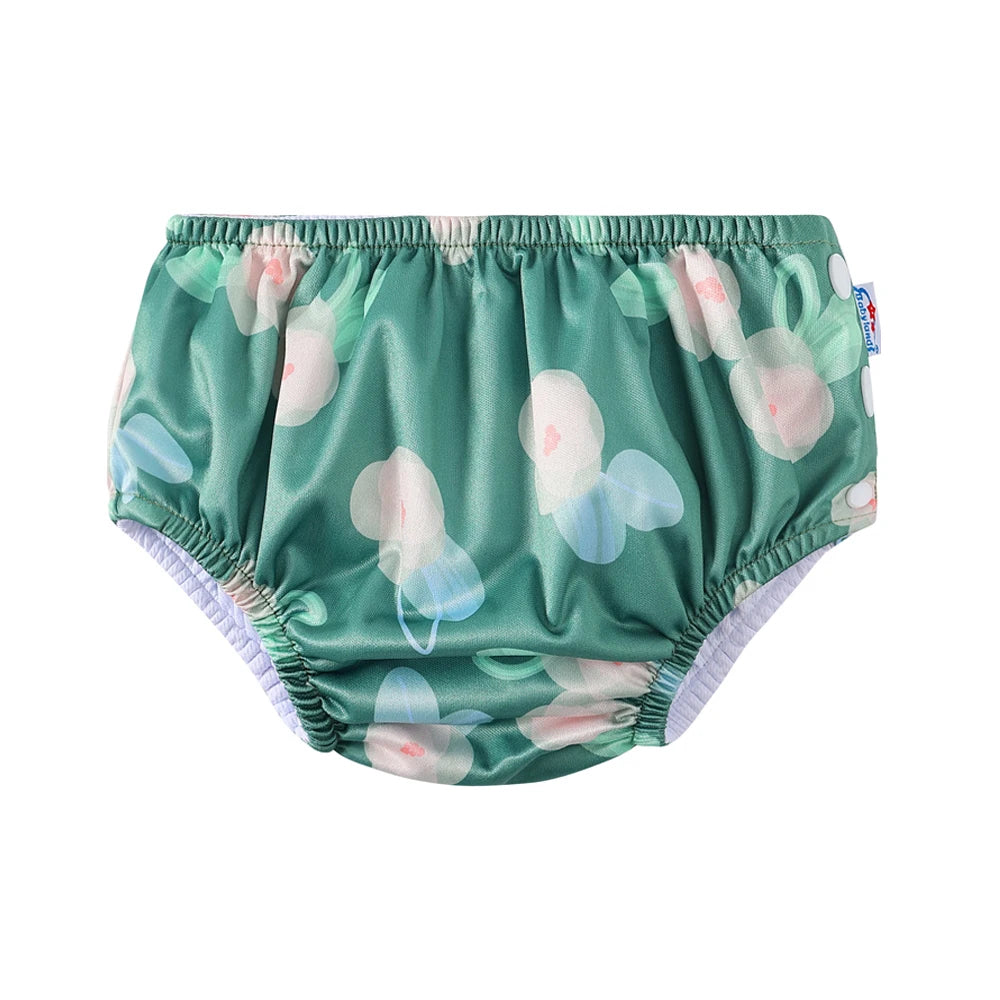 Babyland reusable baby cloth swim diaper in green floral print. Adjustable baby care diaper for water play.