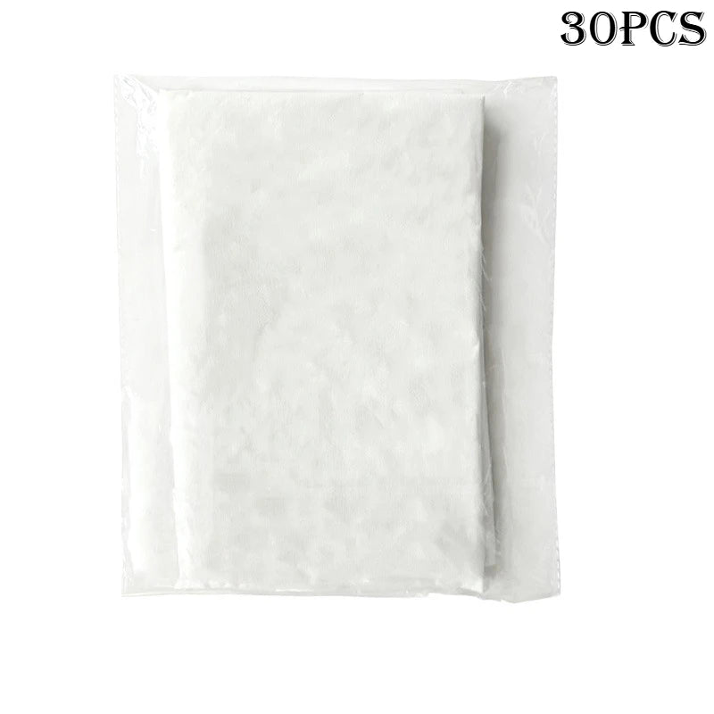 A stack of rectangular, white nonwoven spa face cradle covers sealed in a clear plastic protective sleeve.