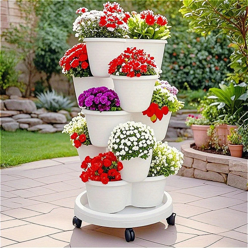 Stackable vertical garden planter with wheels, white pots filled with red and purple flowers outdoors.