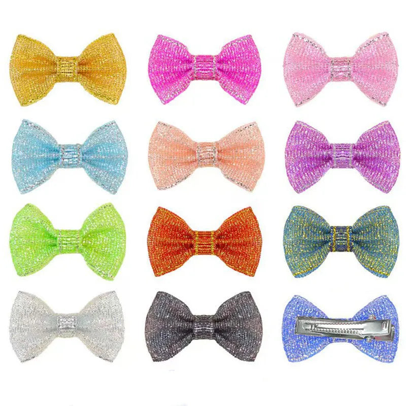 Multi-colored glitter bow hair clips for small dogs and cats. Cute sparkling grooming barrettes for pet styling.