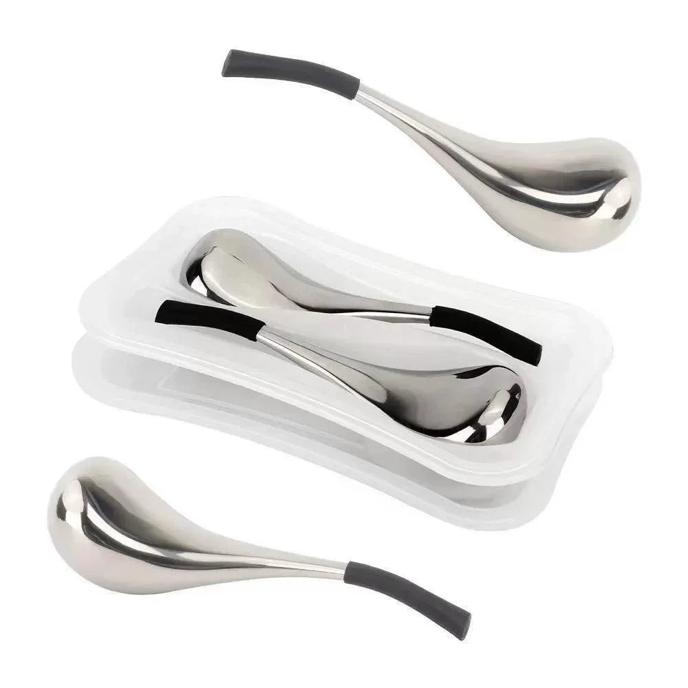 Two silver, teardrop-shaped stainless steel facial cooling globes with black grips, shown in a white plastic tray.