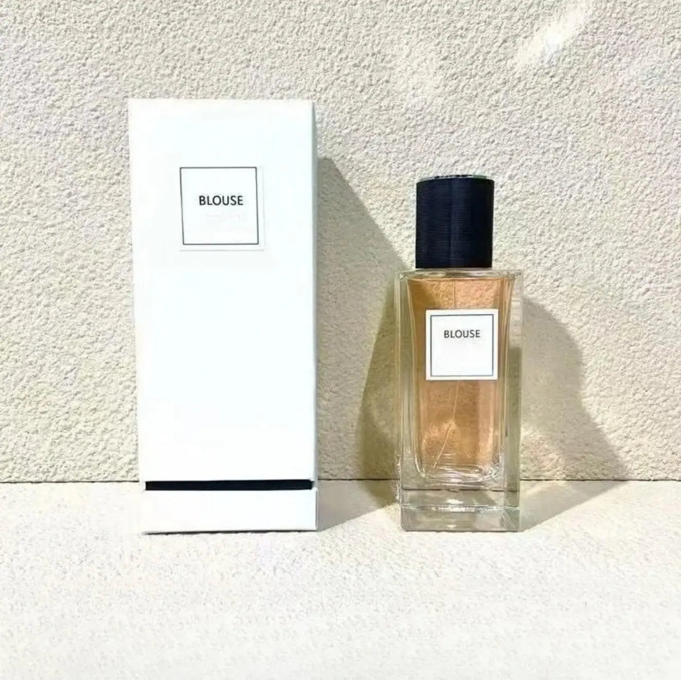 Blouse 125ml unisex oriental woody grapefruit floral perfume. Sleek rectangular glass bottle, black cap, elegant box.
