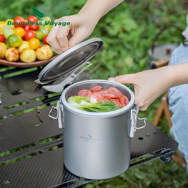 Titanium cooking pot with lid open, filled with vegetables and meat, silver