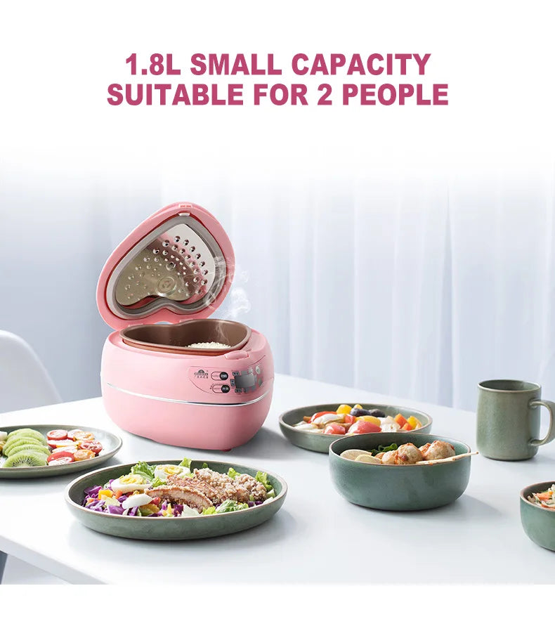 Pink mini rice cooker with open inner pot showing heart-shaped cooking surface