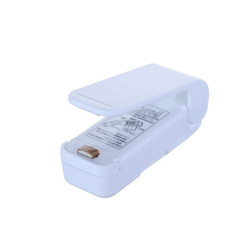 White mini vacuum sealer machine with open lid and sealing strip