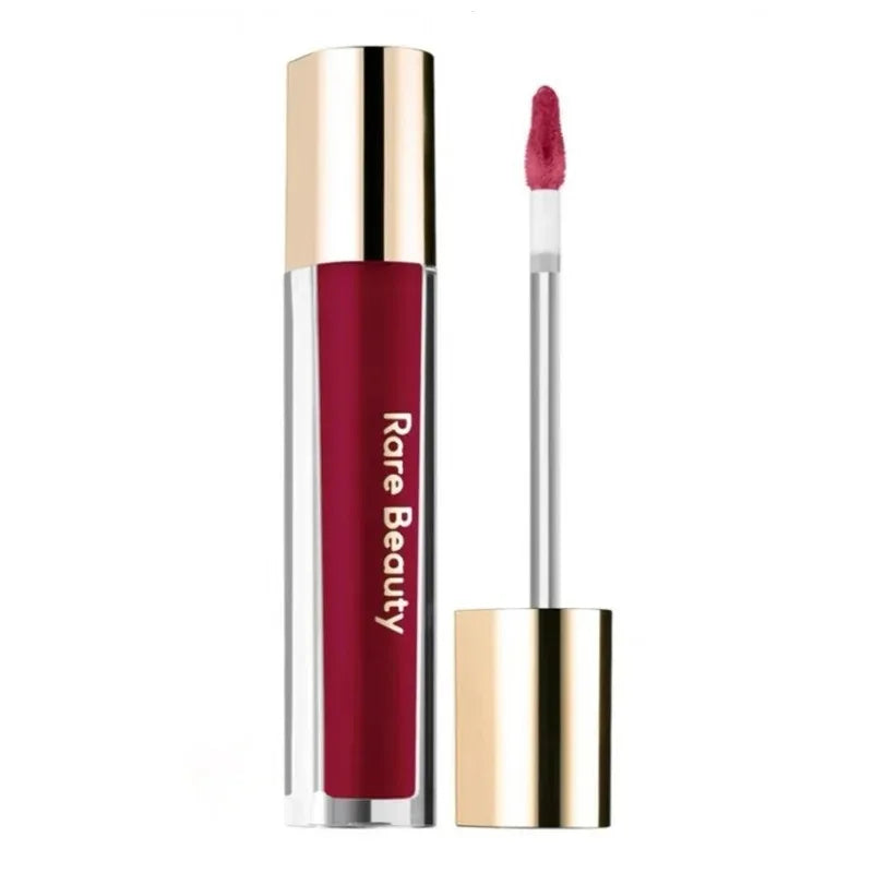 Rare Beauty Soft Pinch Tinted Lip Oil with doe-foot applicator in a deep berry red shade, glossy and hydrating finish.