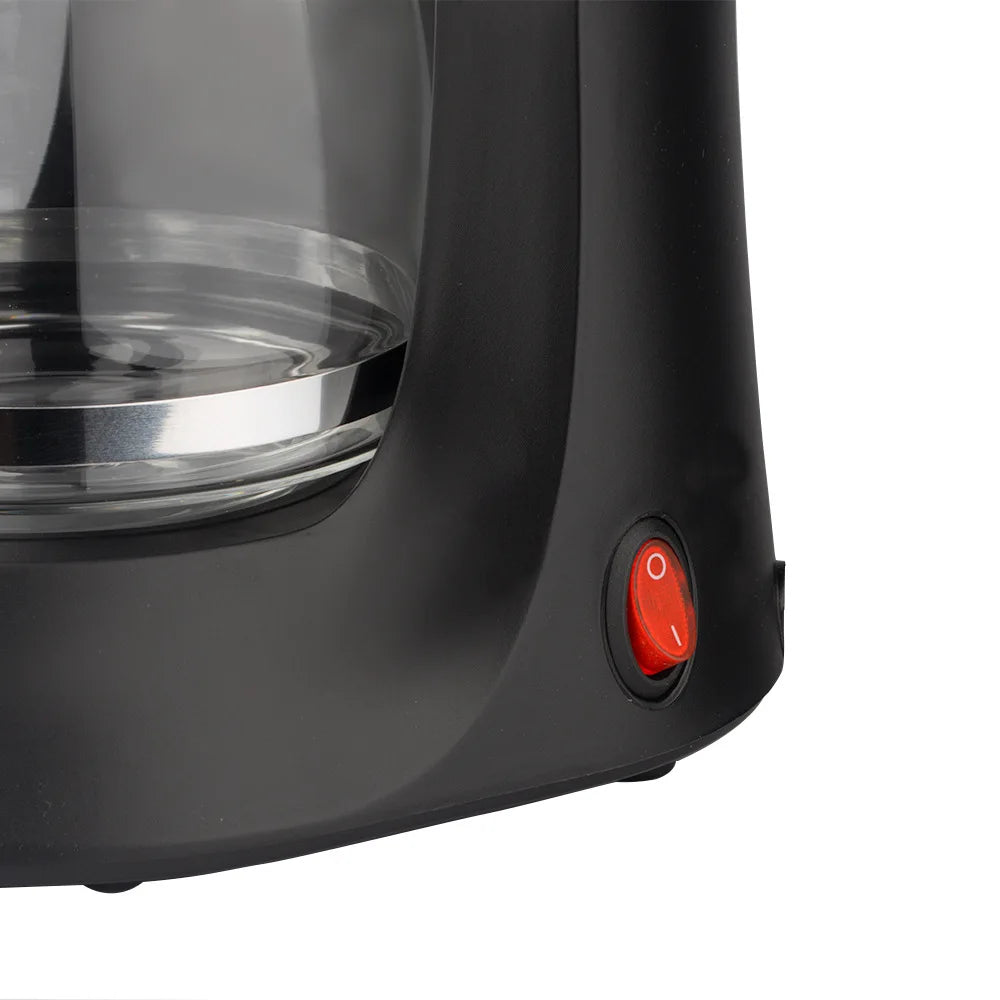 Black plastic coffee maker with a glass carafe and red power toggle switch on the base.