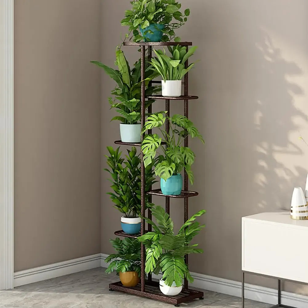 Multi-tier plant display shelf with dark metal frame, holds multiple potted plants