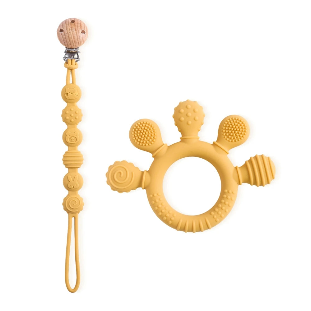 Yellow silicone baby teething ring and pacifier clip toy for pain relief.
