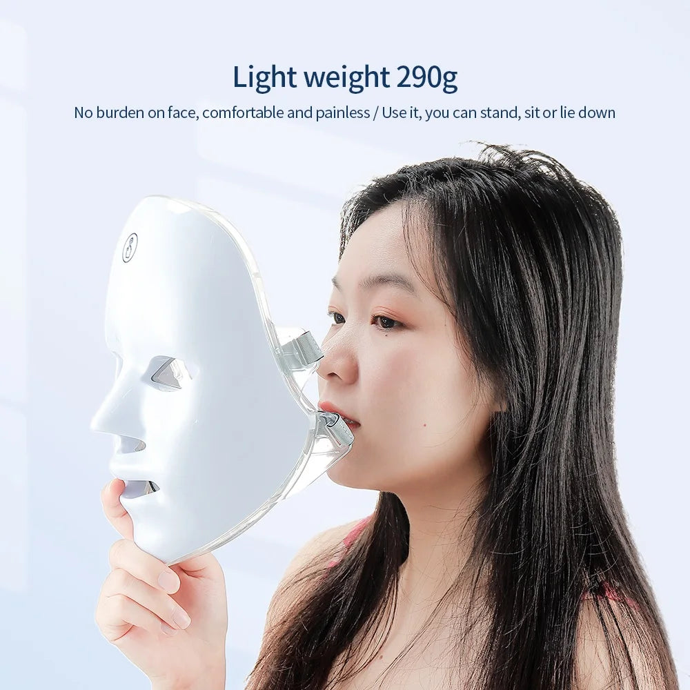 Woman holding a white, lightweight LED facial therapy mask for skin rejuvenation.