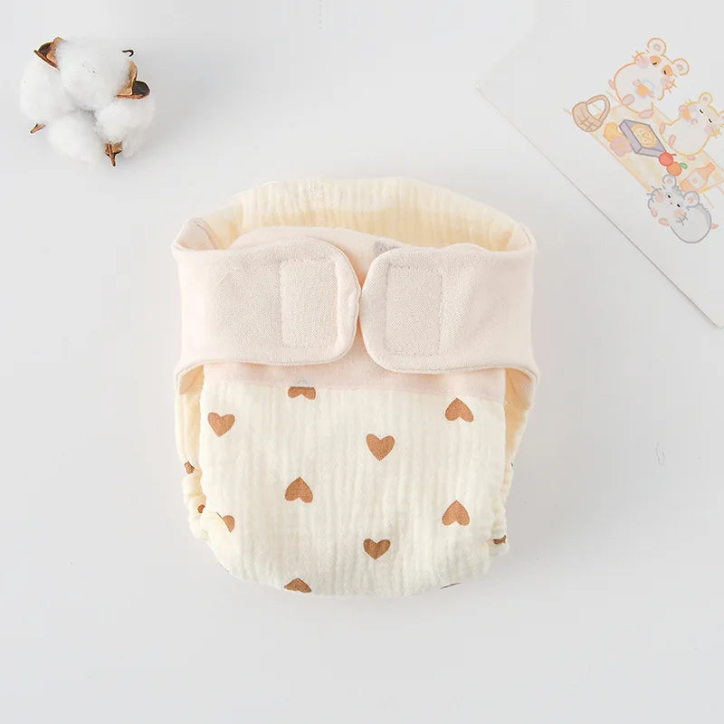 Reusable muslin baby diaper with brown heart pattern, featuring adjustable velcro fasteners for a soft, secure fit.