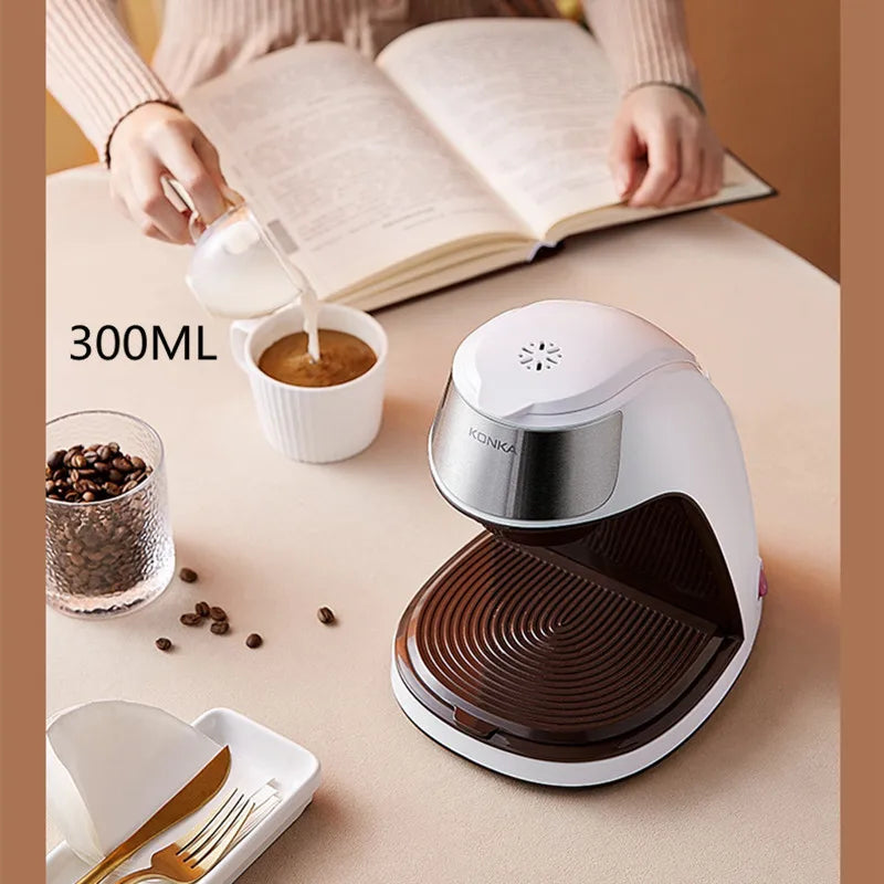 Konka 300ml white and brown single-serve coffee maker on a table with coffee beans and a person pouring milk.