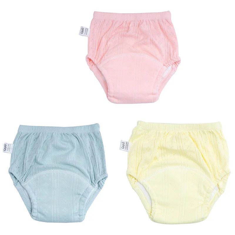 Set of 3 UoU baby potty training diapers in pink, blue, and yellow with breathable, absorbent cotton fabric.