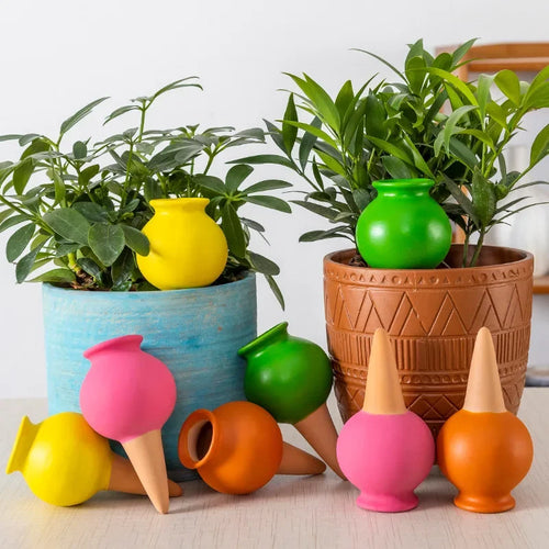 Ceramic self-watering drip irrigation droppers in assorted colors, with plant-pot cones