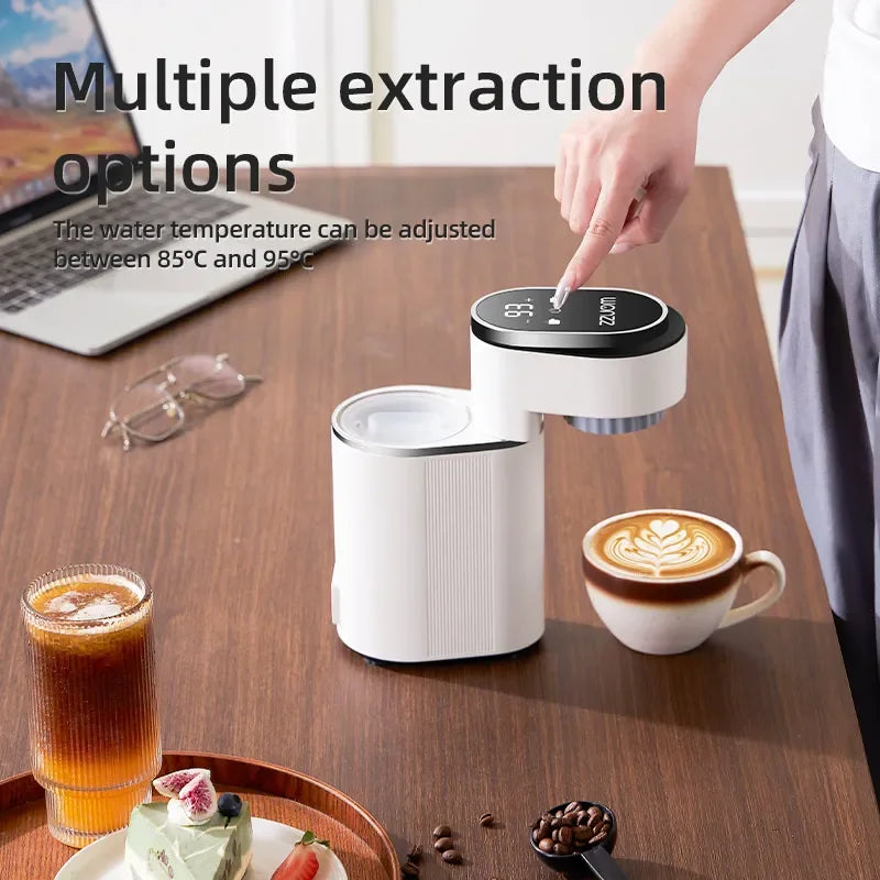 White compact ZZUOM portable coffee maker with digital temperature control touch display on a wooden desk.